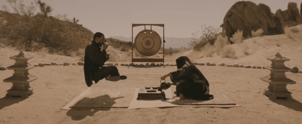 Two people in a deserted environment in a music video